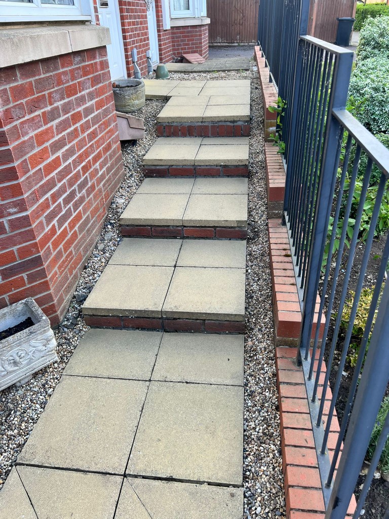 Clean jet-washed paving steps and pathway alongside a property in Essex